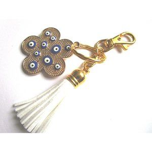 Gold tone blue evil eye flower charm key chain white leather tassel purse charm